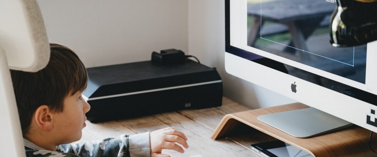 boy looking at computer