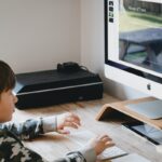 boy looking at computer